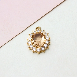 Macro detail of oval champagne zircon pendant with gold-plated setting for jewelry making