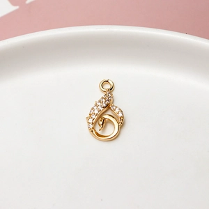 Detail of a swan-shaped gold pendant with sparkling white cubic zirconia inlay