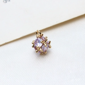 Macro shot of a purple cubic zirconia stone wrapped in gold geometric metal frame