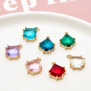 Macro detail of geometric teardrop glass pendants with gold-plated DIY jewelry settings