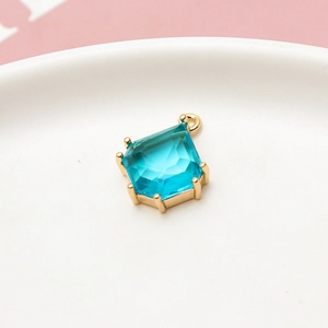 Macro detail of sky blue teardrop crystal pendant with gold claw setting for DIY jewelry