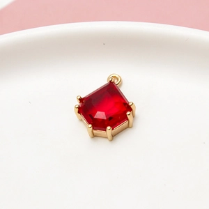 Macro shot of a red geometric teardrop pendant with gold plated copper edging