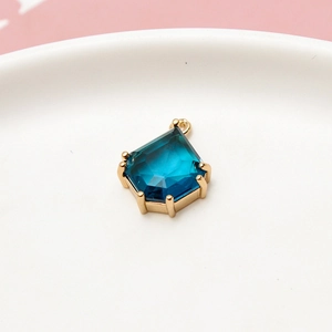 Macro view of teardrop blue faceted gemstone pendant with gold-plated hexagonal claw setting