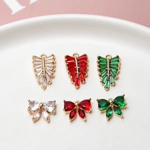 Macro view of copper leaf and bow pendants with zircon inlays for DIY jewelry making