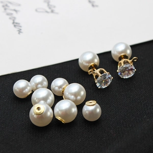 Vue macro de fermoirs en perles blanches et clous d'oreilles en zircon plaqués or