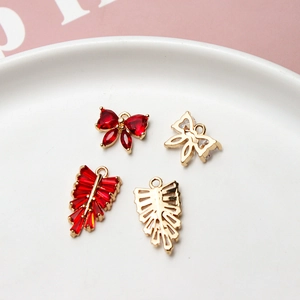 Gold-plated bow and leaf charms with red zircon stones for DIY jewelry making