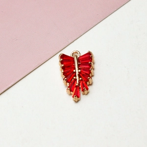 Macro view of gold copper leaf pendant with rectangular red zircon inlay and top ring
