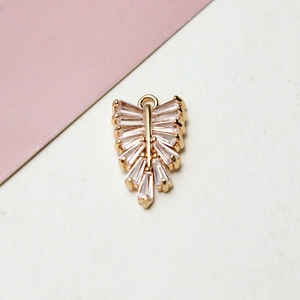 Macro shot of gold-plated leaf charm pendant with cubic zirconia for DIY jewelry making