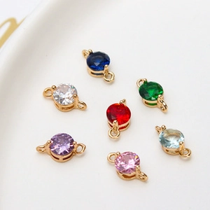 Macro shot of colorful oval birthstone charms with gold plated connectors for DIY jewelry