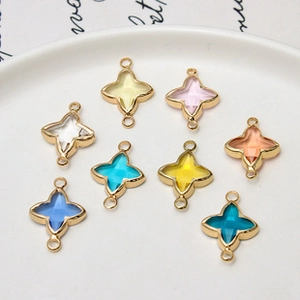Detailed view of colorful star-shaped crystal pendants with gold edges and dual rings