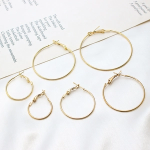 Three pairs of classic gold-plated geometric hoop earrings in small, medium, and large sizes