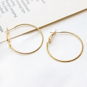 Macro shot of minimalist gold plated round hoop earrings with secure leverback closures