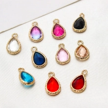 Detailed view of colorful teardrop crystal pendants with engraved gold alloy edges