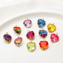 Flat lay of heart-shaped glass pendants with gold edges for DIY jewelry making