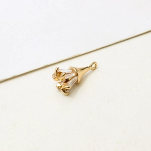 Detailed macro view of gold-plated copper pendant featuring rectangular zircon inlays