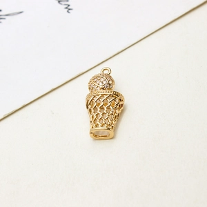 Macro shot of gold-plated basketball hoop pendant with zircon pave and hollow net