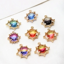 Macro detail of eight colorful starburst charms with golden metal frames for DIY jewelry