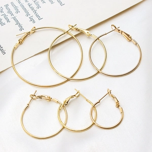 Three pairs of shiny gold plated round hoop earrings in small medium and large sizes