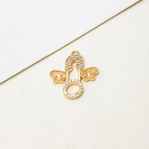 Macro view of gold-plated angel wing safety pin pendant with micro-set zircons