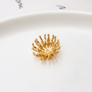 Gros plan sur calotte de fleur évidée en laiton doré pour bijoux de mariée DIY