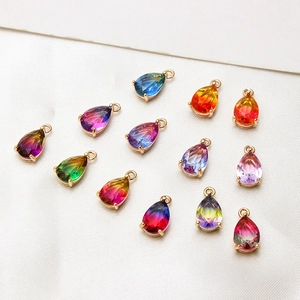 Detailed view of colorful gradient teardrop charms with gold-plated copper frames for DIY jewelry