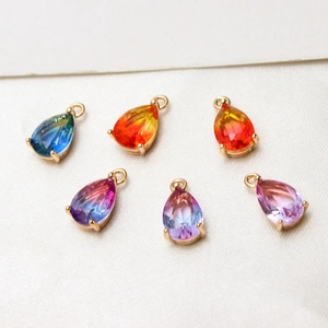 Detail of faceted gradient glass teardrop charms with gold plated copper borders