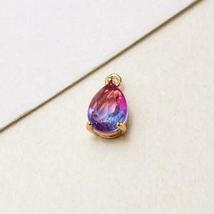 Detailed view of teardrop gradient glass charm with gold-plated bezel for DIY jewelry