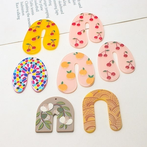 Detail of colorful acrylic U-shape arch charms with cherry and floral prints for DIY jewelry