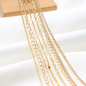 Detailed macro view of various gold-plated flat O-chains and link styles for DIY jewelry