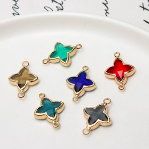 Macro detail of six-color four-pointed star pendants with gold-plated copper edges for DIY