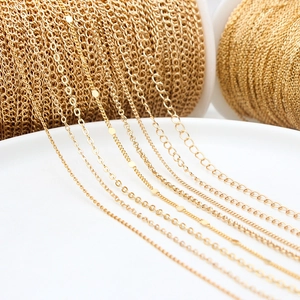 Detailed macro shot of various gold-plated DIY jewelry chains on white ceramic plate