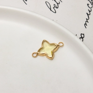 Macro detail of gold-plated star charm with translucent yellow inlay for DIY jewelry