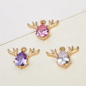 Macro shot of cubic zirconia elk deer head charms in gold for DIY jewelry making