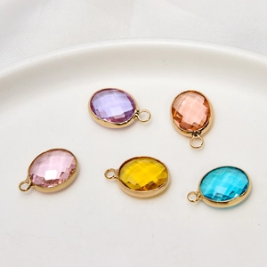 Five oval faceted crystal glass pendants with gold edges in purple pink and blue