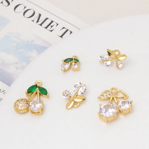 Gold-plated cherry pendants set with sparkling white and green cubic zirconia stones