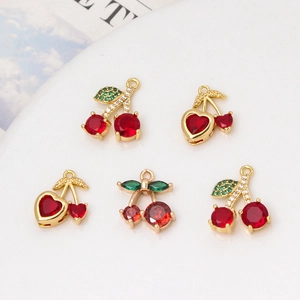 Five gold-plated cherry pendants with red and green zircons for jewelry making