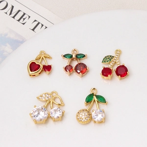 Macro shot of red cubic zirconia cherry charms with gold plating for jewelry making