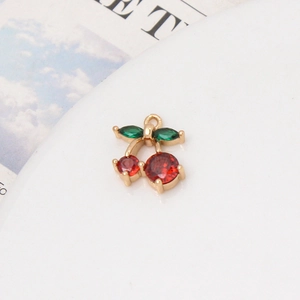 Detailed macro view of cherry pendant with red and green cubic zirconia stones