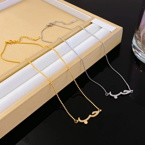 Gold and silver Arabic 'Love' necklaces with cubic zirconia on a minimalist bead chain