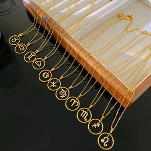 Detail of 12 gold plated zodiac necklaces with micro-inlaid rhinestones on velvet