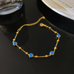 Bracelet vintage plaqué or avec perles de l'œil bleu et petites billes polies