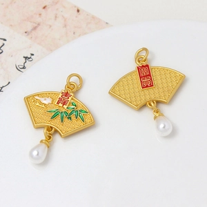 Macro detail of fan-shaped golden pendants with green bamboo enamel and teardrop pearls