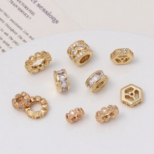 Detailed view of gold plated cubic zirconia spacer beads and geometric DIY jewelry components
