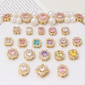 Flat lay of colorful cubic zirconia charms in gold plating for DIY jewelry making