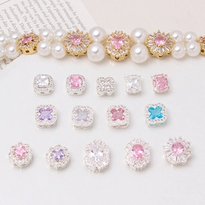 Detail of cubic zirconia flower spacers and colorful pendants for DIY jewelry making