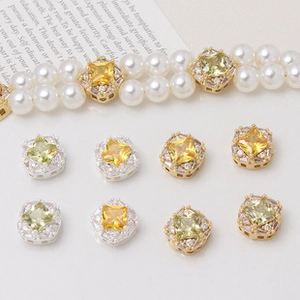 Detail of gold-plated four-leaf flower spacer with zircons for DIY jewelry making