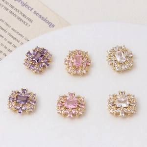 Detailed view of vintage gold plated beads with purple and pink crystal inlay