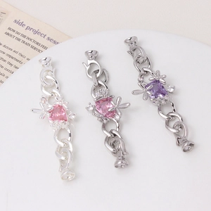 Macro view of flower and dragonfly charms with cubic zirconia for jewelry making