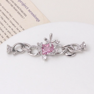 Detail of silver floral jewelry clasp with pink gemstone and micro-pave cubic zirconia
