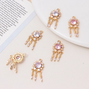 Dreamcatcher pendant with cubic zirconia ribbons and feather charms in 18K gold plating